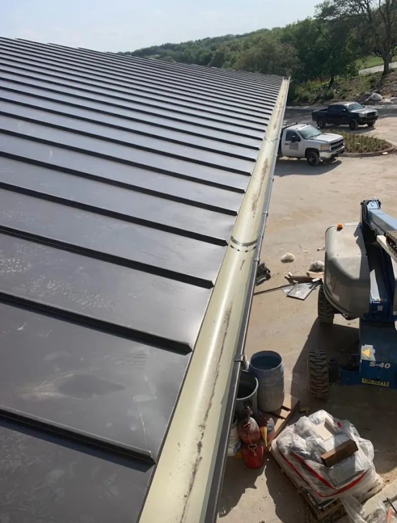 Standing seam panel and gutter detail on a metal roofing jobsite in Sauk Rapids